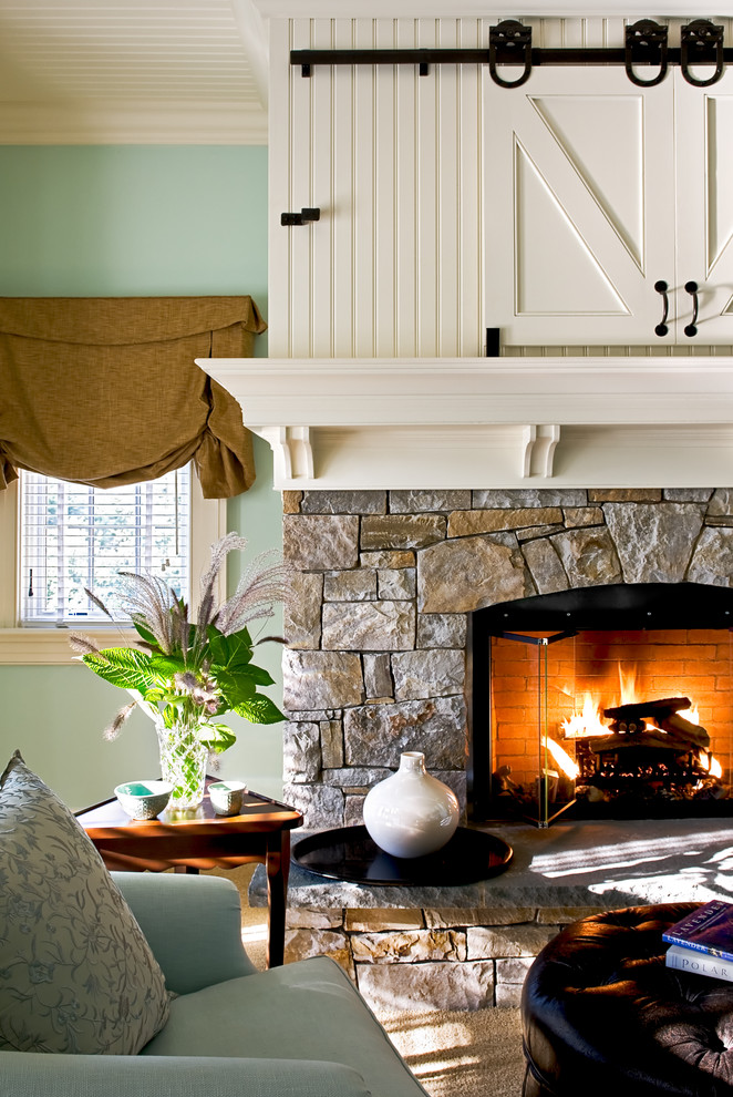 Inspiration for a timeless bedroom remodel in New York with green walls, a stone fireplace and a standard fireplace