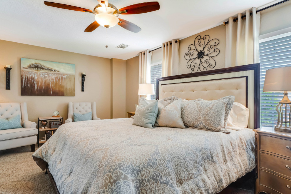 Large classic master bedroom in Houston with beige walls, carpet, no fireplace and beige floors.