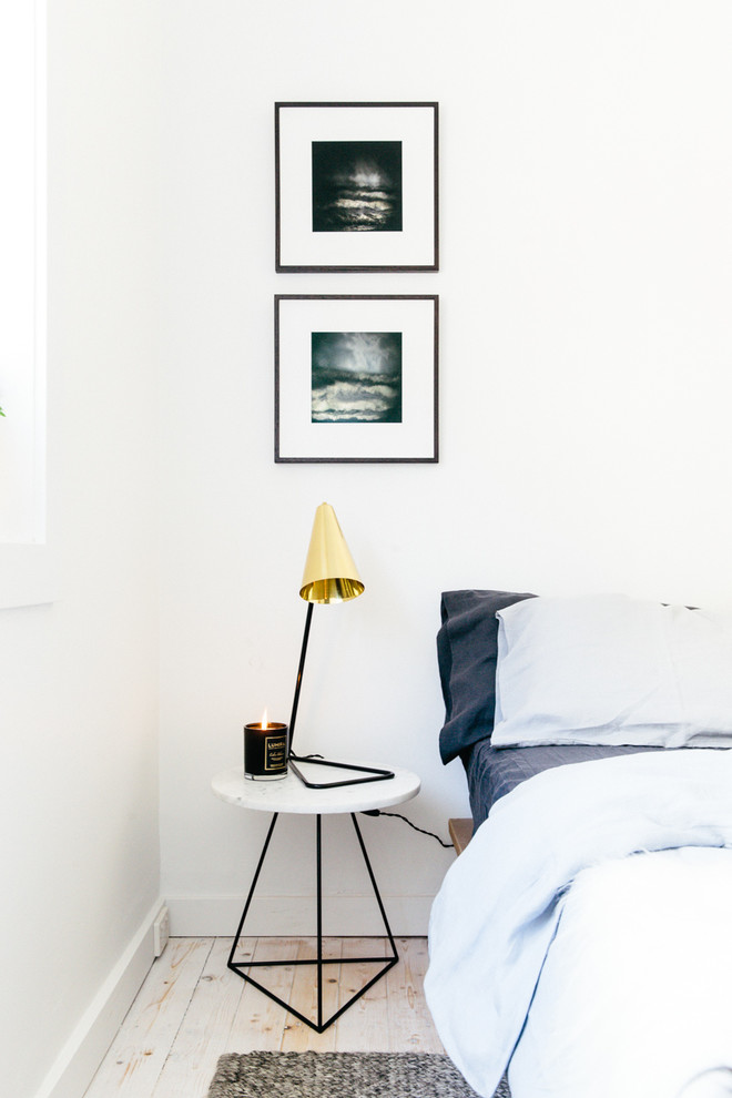 Example of a small danish guest painted wood floor bedroom design in Sydney with white walls