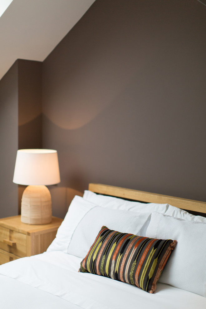 Mid-sized trendy bedroom photo in Kent with brown walls
