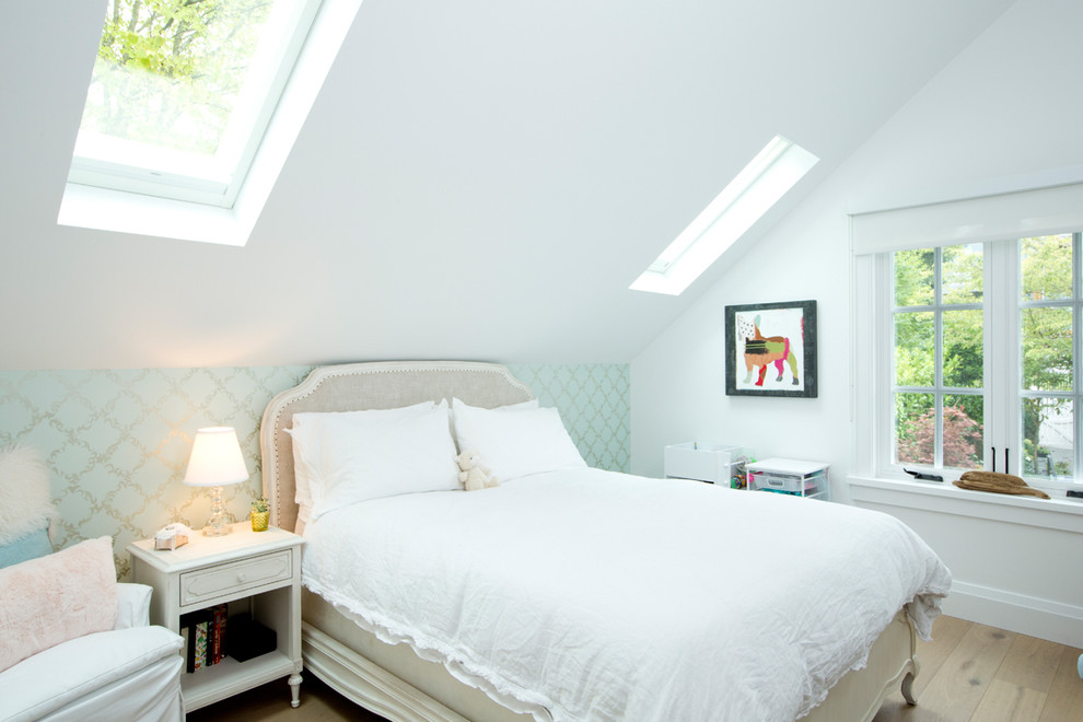 Traditional bedroom in Vancouver with white walls and medium hardwood flooring.