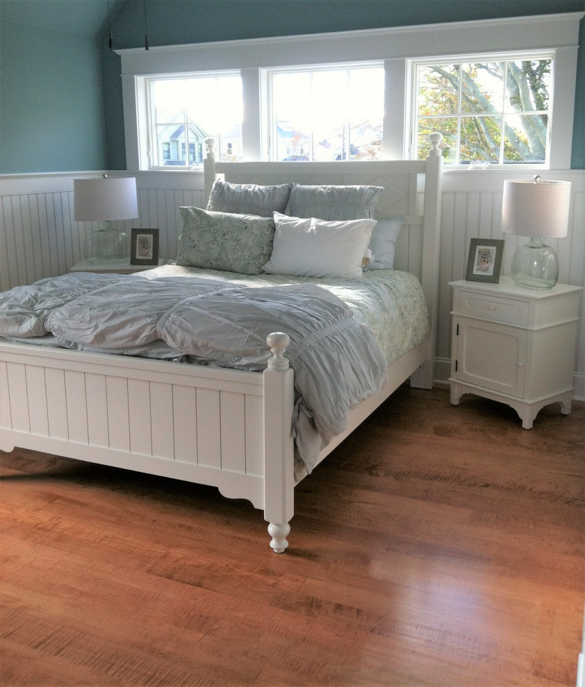 Photo of a medium sized traditional guest bedroom in Providence with blue walls, medium hardwood flooring, red floors and wainscoting.