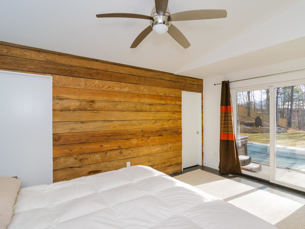 Small contemporary master bedroom in Charlotte with concrete flooring, white walls and no fireplace.