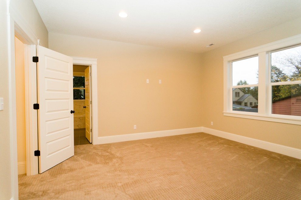 Large arts and crafts master carpeted bedroom photo in Portland with beige walls and no fireplace