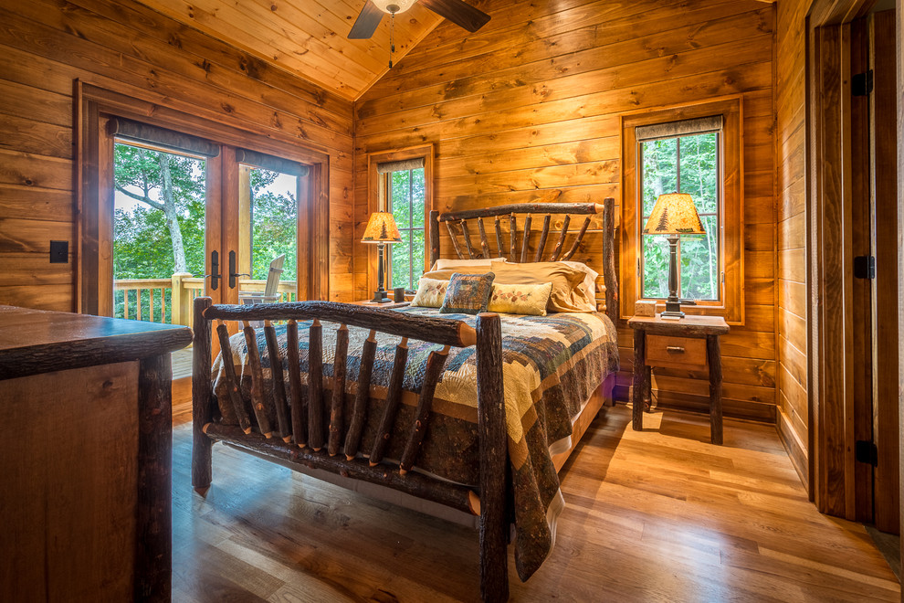 Photo of a medium sized rustic master bedroom in Charlotte with brown walls, medium hardwood flooring, no fireplace and brown floors.