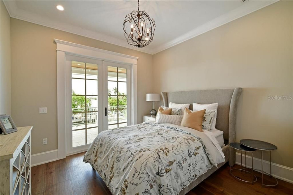 This is an example of a nautical guest bedroom in Tampa with beige walls, medium hardwood flooring and brown floors.