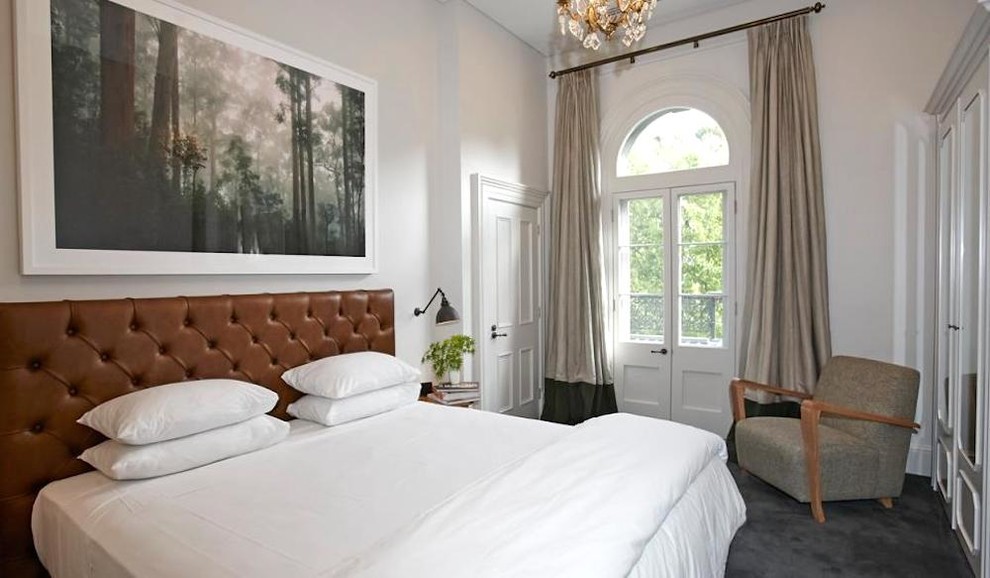 Imagen de dormitorio principal actual de tamaño medio con paredes beige, moqueta y suelo gris