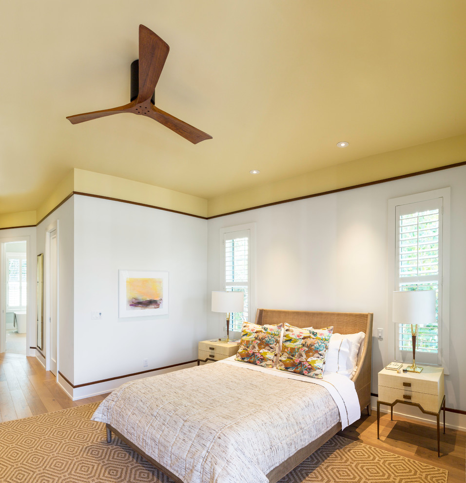 Photo of a large contemporary master bedroom in Miami with white walls, light hardwood flooring and beige floors.