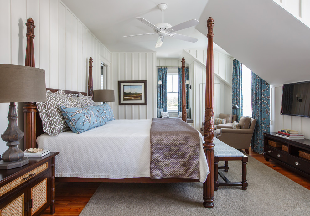 Foto di una camera da letto stile marinaro con pareti bianche, pavimento in legno massello medio, pavimento marrone e TV