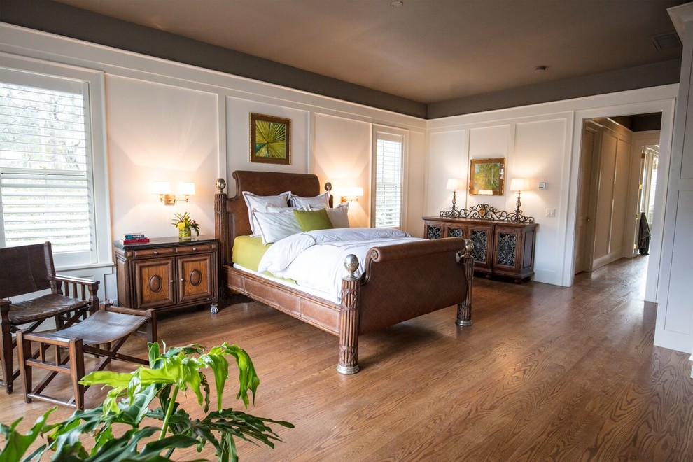 Example of a large classic master medium tone wood floor and brown floor bedroom design in Atlanta with white walls and no fireplace