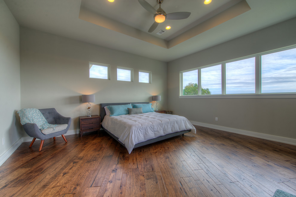 Inspiration for a modern master medium tone wood floor and brown floor bedroom remodel in Austin with gray walls