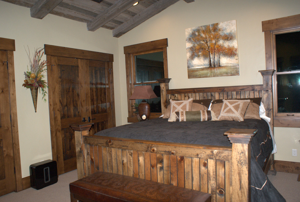 Inspiration for a large rustic master bedroom in Salt Lake City with beige walls, carpet, no fireplace and grey floors.