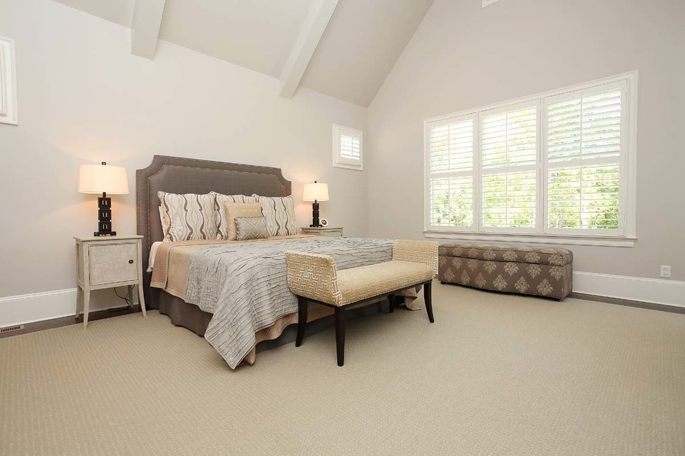 Bedroom - large traditional master carpeted bedroom idea in Charlotte with gray walls