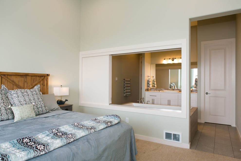 This is an example of a medium sized contemporary master bedroom in Portland with beige walls, carpet and beige floors.
