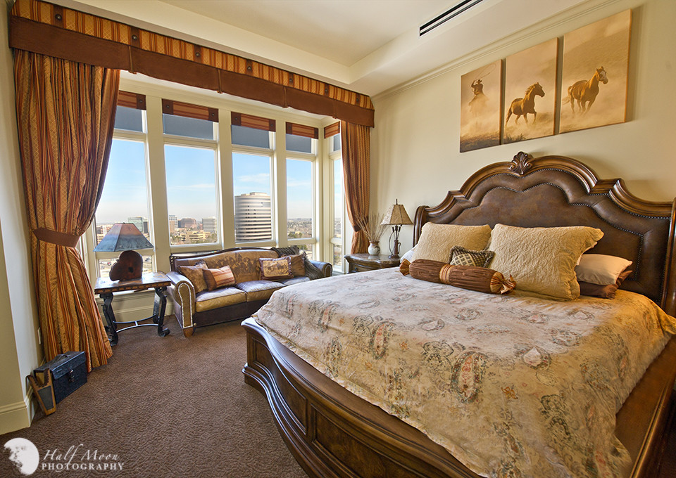 Large transitional master carpeted bedroom photo in Denver with beige walls, a corner fireplace and a tile fireplace