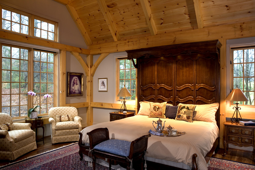 Imagen de dormitorio principal rústico grande sin chimenea con paredes grises y suelo de madera oscura