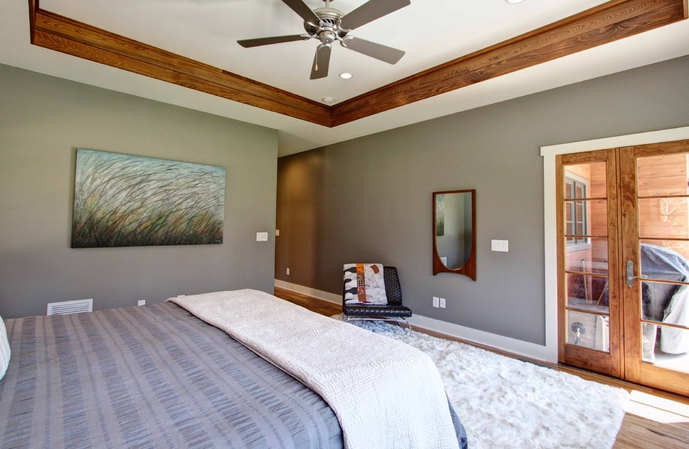 Mid-sized minimalist master medium tone wood floor bedroom photo in Other with gray walls and no fireplace
