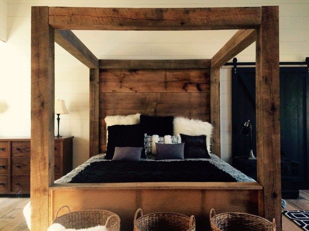 Inspiration for a large rustic master medium tone wood floor bedroom remodel in Philadelphia with white walls and no fireplace
