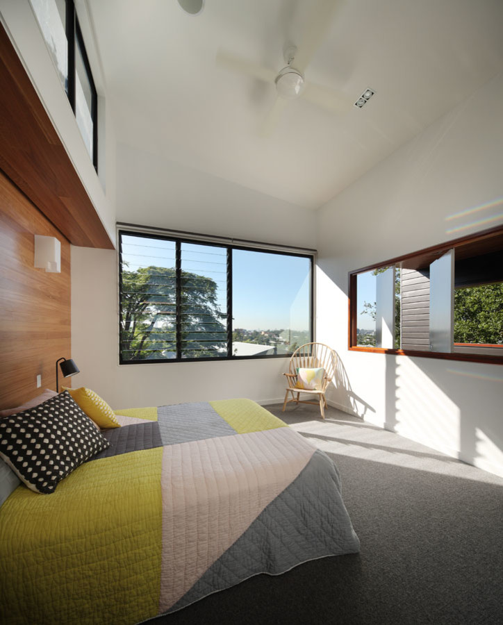Photo of a contemporary master bedroom in Brisbane with white walls and carpet.