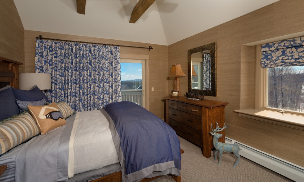 This is an example of a large rustic master bedroom in Burlington with beige walls, carpet and beige floors.