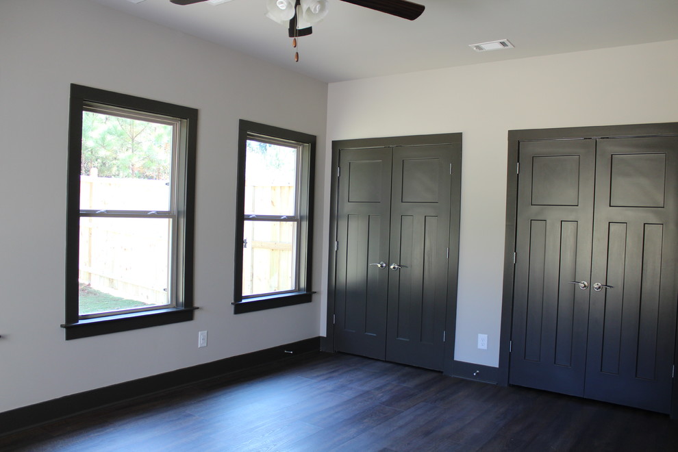 Mid-sized arts and crafts master vinyl floor and black floor bedroom photo in Atlanta with white walls and no fireplace