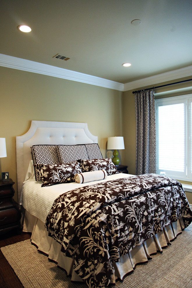 Traditional bedroom in Dallas with beige walls and dark hardwood flooring.