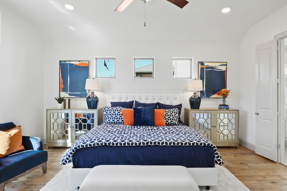 Large elegant master medium tone wood floor and beige floor bedroom photo in Dallas with white walls