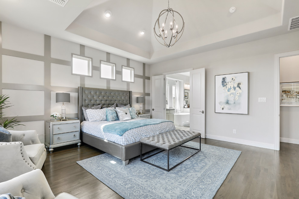 Inspiration for a large classic master bedroom in Dallas with grey walls, medium hardwood flooring and brown floors.