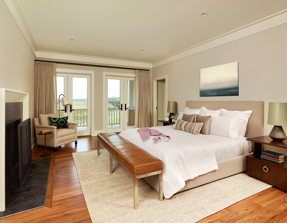 На фото: спальня в морском стиле с бежевыми стенами, паркетным полом среднего тона и стандартным камином с