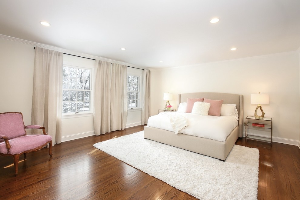 Large transitional master medium tone wood floor and brown floor bedroom photo in New York with beige walls and no fireplace