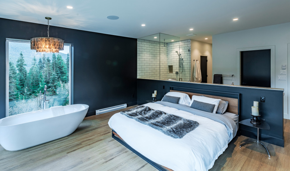 This is an example of a large modern master bedroom in Vancouver with black walls, vinyl flooring and brown floors.
