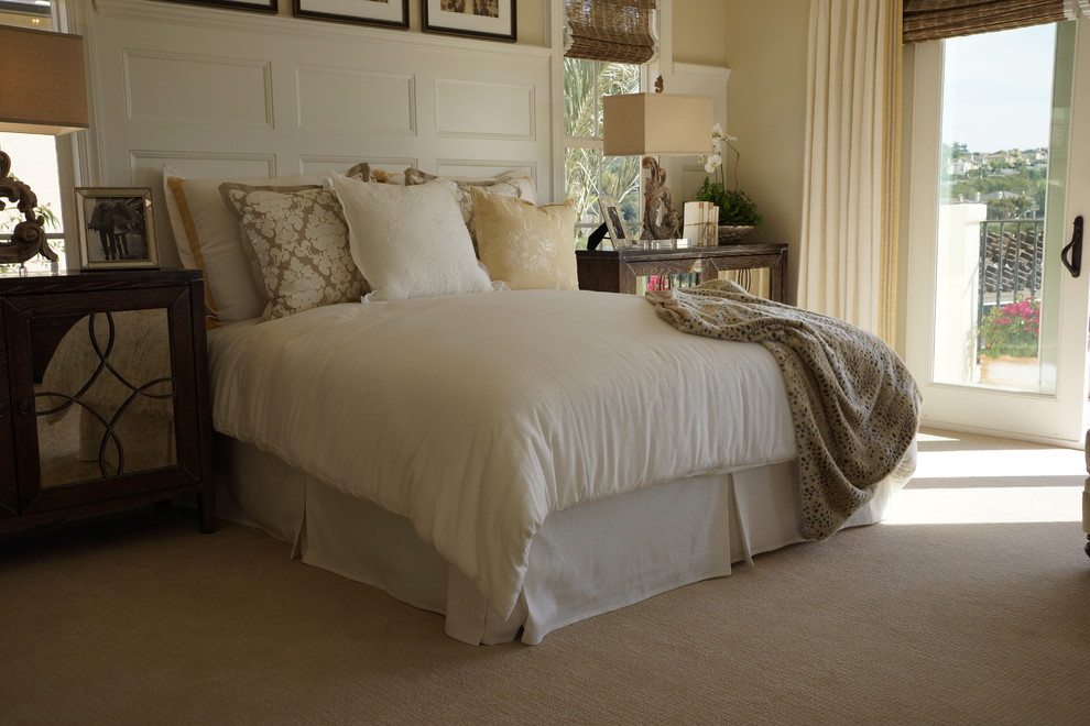 Inspiration for a large mediterranean master carpeted bedroom remodel in San Diego with beige walls