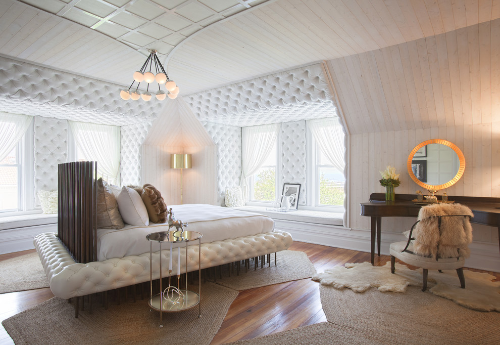 Contemporary bedroom in London with medium hardwood flooring.
