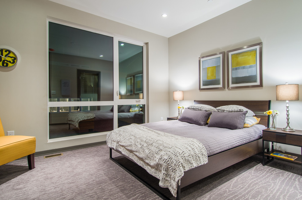 Foto de dormitorio actual con paredes grises y moqueta