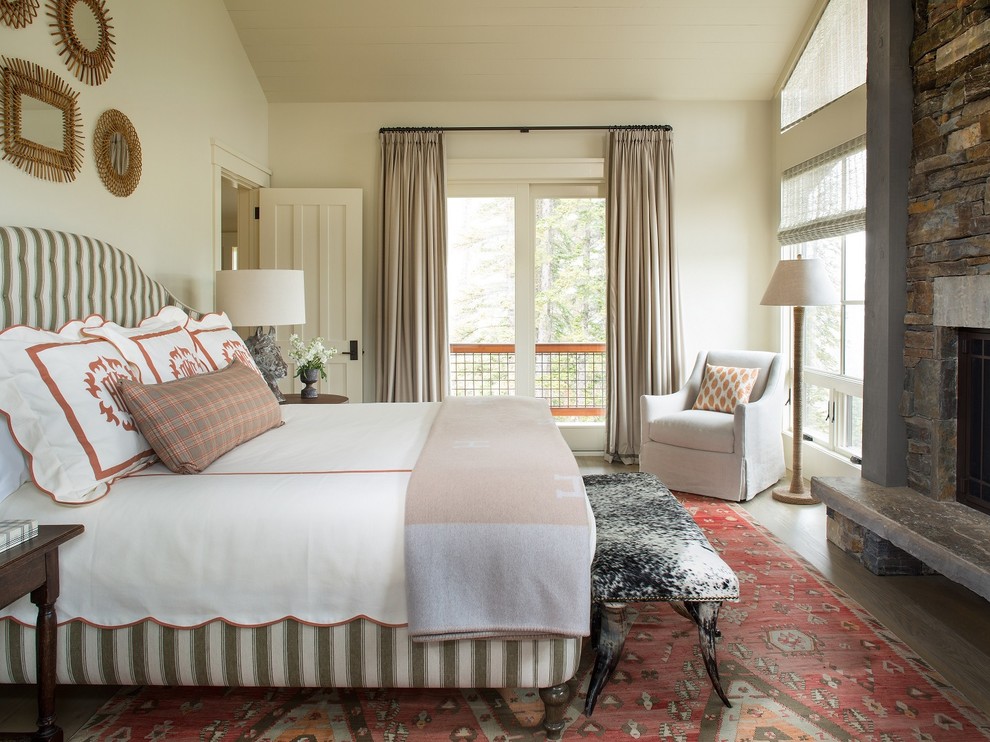 Bedroom - rustic master bedroom idea in Seattle with beige walls, a standard fireplace and a stone fireplace