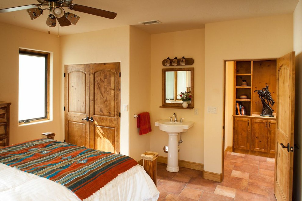 Cette image montre une chambre d'amis sud-ouest américain avec un mur beige et un sol en carrelage de céramique.