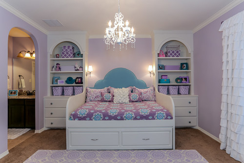 white daybed with white built in bookshelves with purple walls and purple bedding