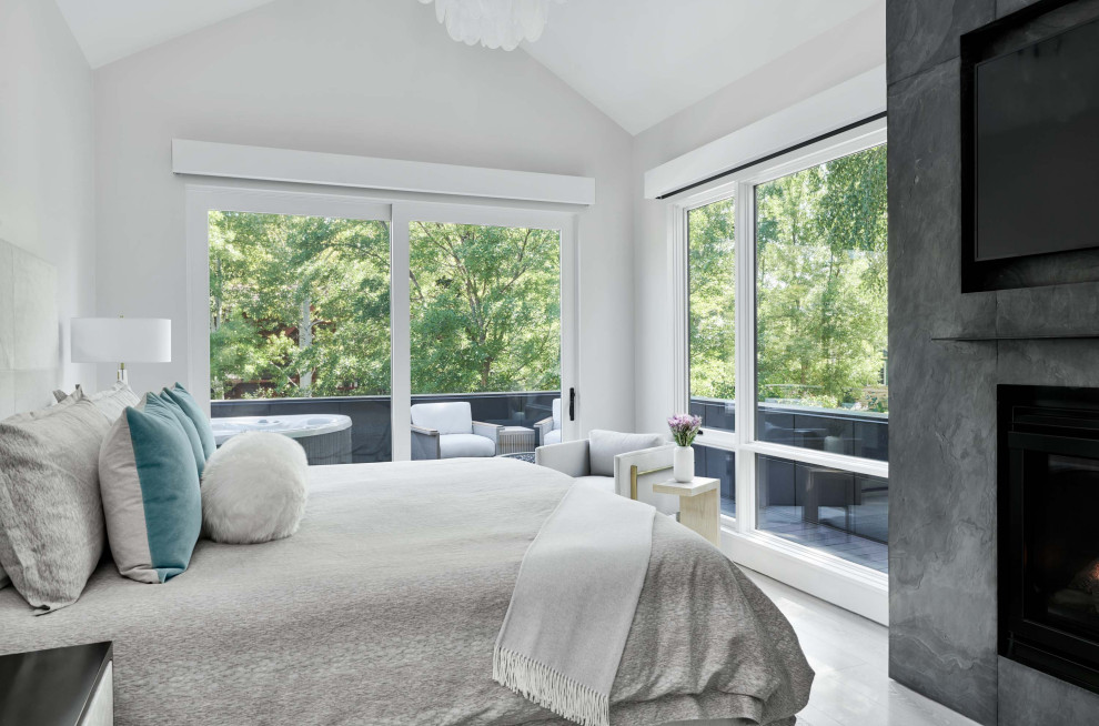 Источник вдохновения для домашнего уюта: хозяйская спальня среднего размера в современном стиле с серыми стенами, светлым паркетным полом, стандартным камином, фасадом камина из бетона, серым полом и сводчатым потолком