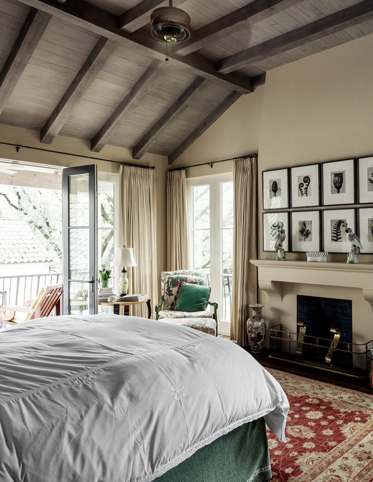 Photo of a mediterranean master and grey and cream bedroom in Dallas with beige walls and a standard fireplace.