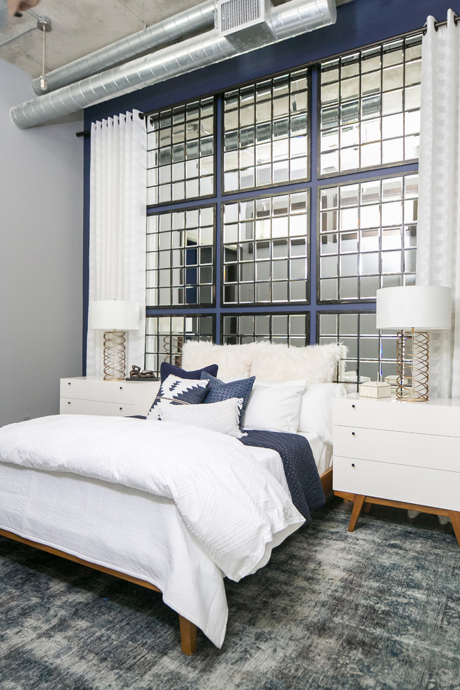 На фото: спальня среднего размера в стиле лофт с синими стенами без камина