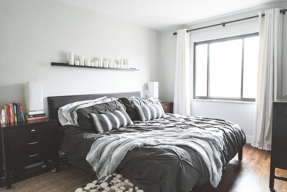 Bedroom - mid-sized modern master medium tone wood floor and brown floor bedroom idea in Denver with white walls