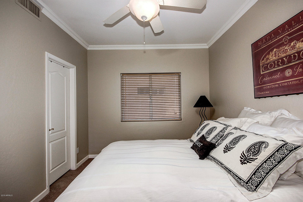 This is an example of a small mediterranean guest bedroom in Phoenix with beige walls.