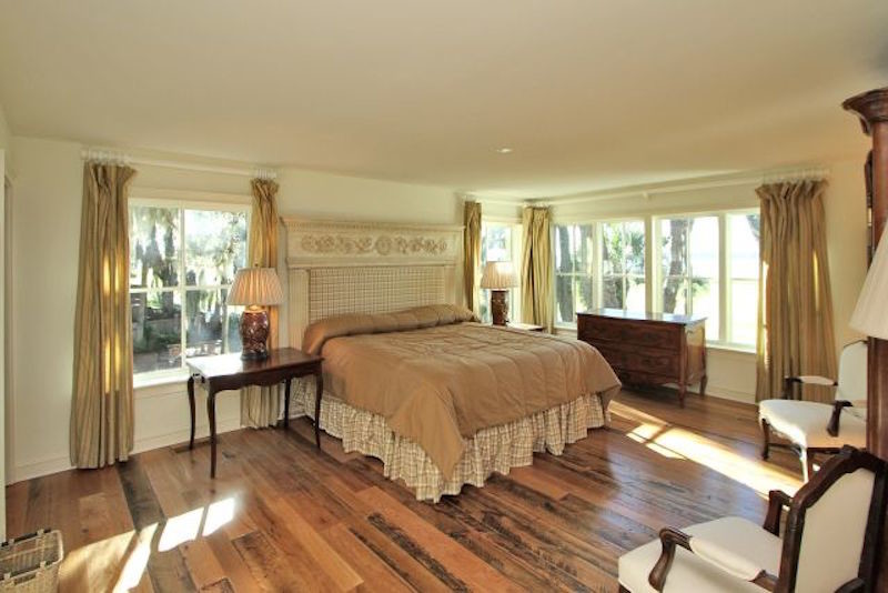Inspiration for a large classic master bedroom in Atlanta with white walls and dark hardwood flooring.