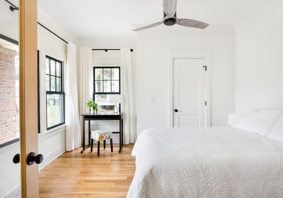 Medium sized traditional guest bedroom in Charlotte with white walls, light hardwood flooring and beige floors.