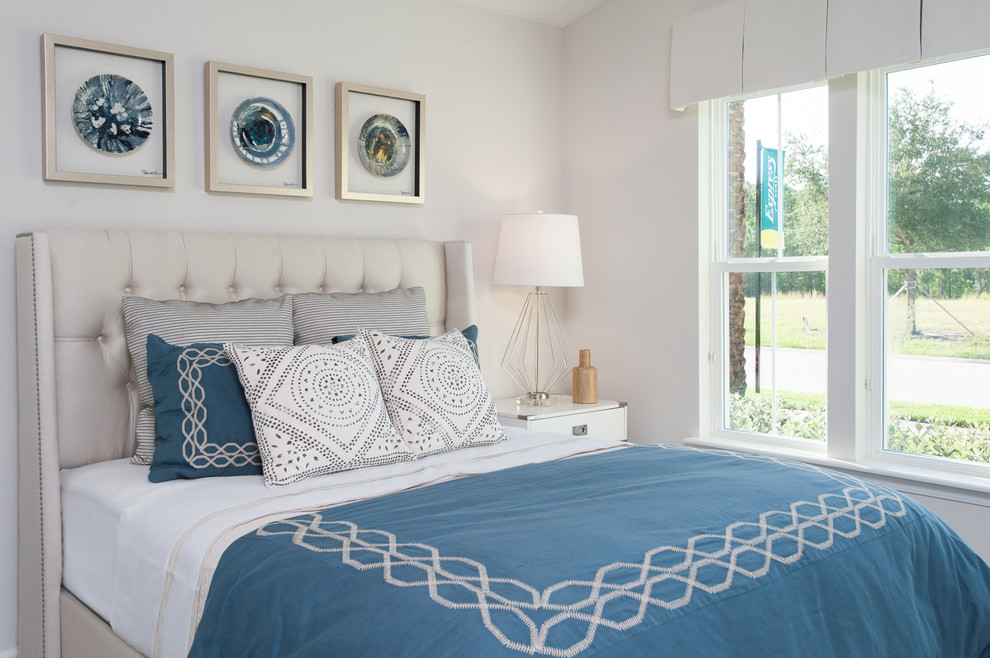 This is an example of a medium sized nautical guest and grey and silver bedroom in Orlando with white walls and carpet.