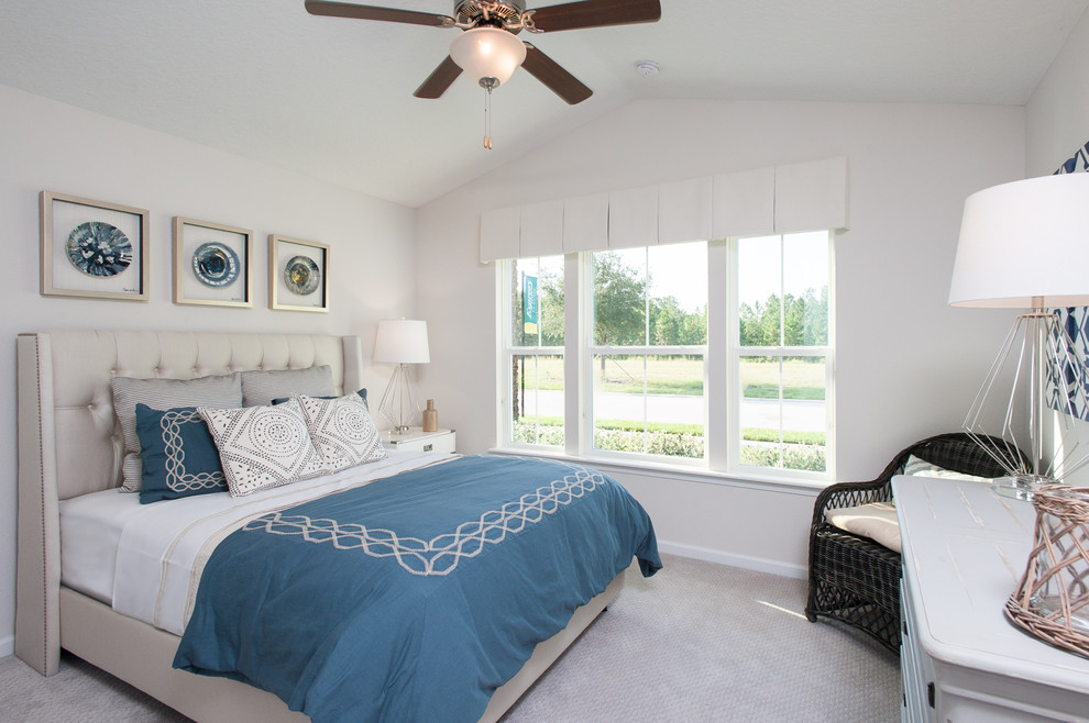 Inspiration for a mid-sized coastal guest carpeted bedroom remodel in Orlando with white walls