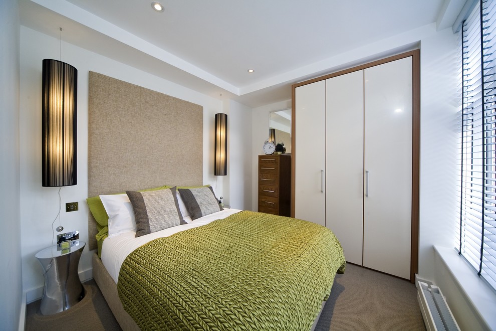 Bedroom - contemporary carpeted bedroom idea in London with white walls