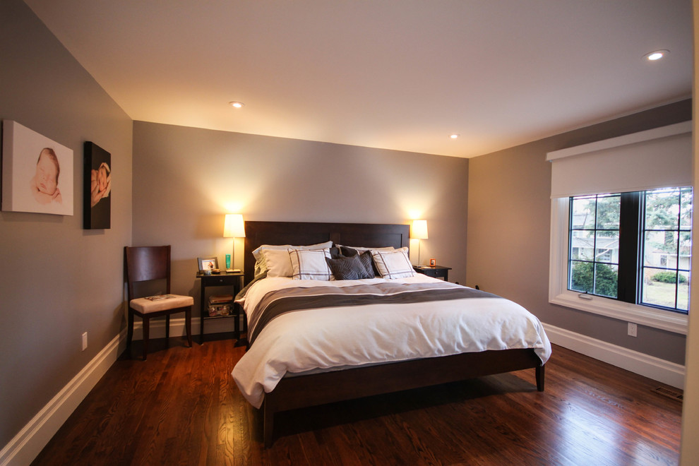 Large traditional master bedroom in Ottawa with grey walls and medium hardwood flooring.