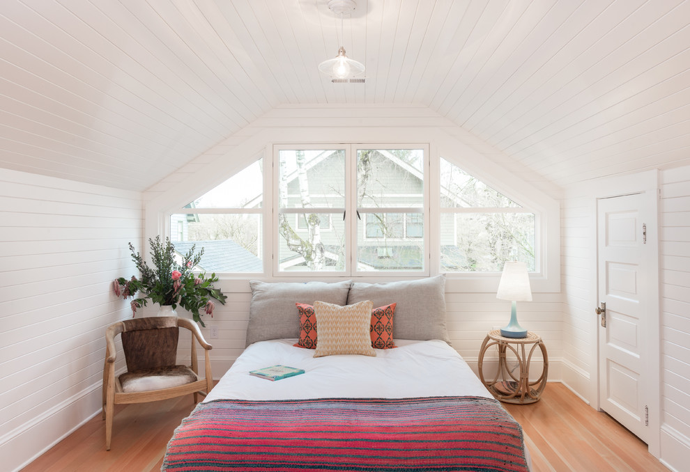This is an example of a small classic master bedroom in Portland with white walls, medium hardwood flooring and brown floors.