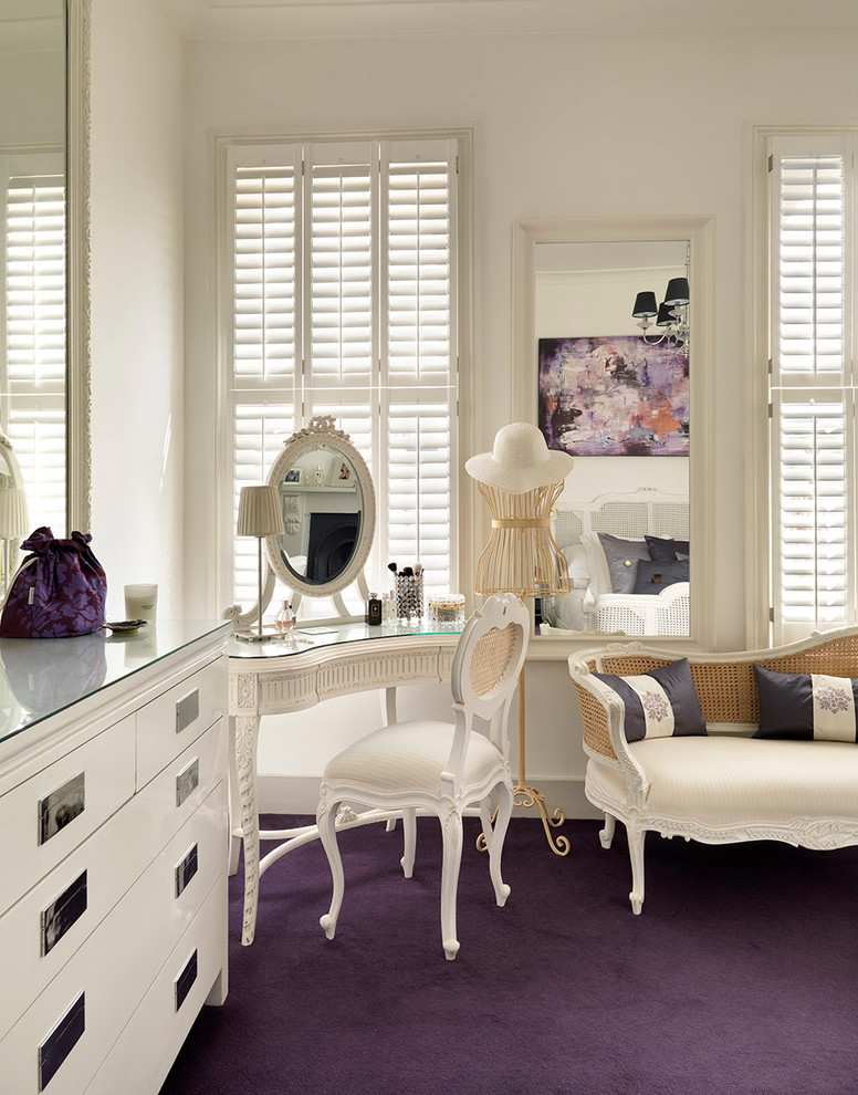 Example of an ornate master carpeted and purple floor bedroom design in London with white walls